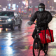 GrubHub delivery person bikes through snow